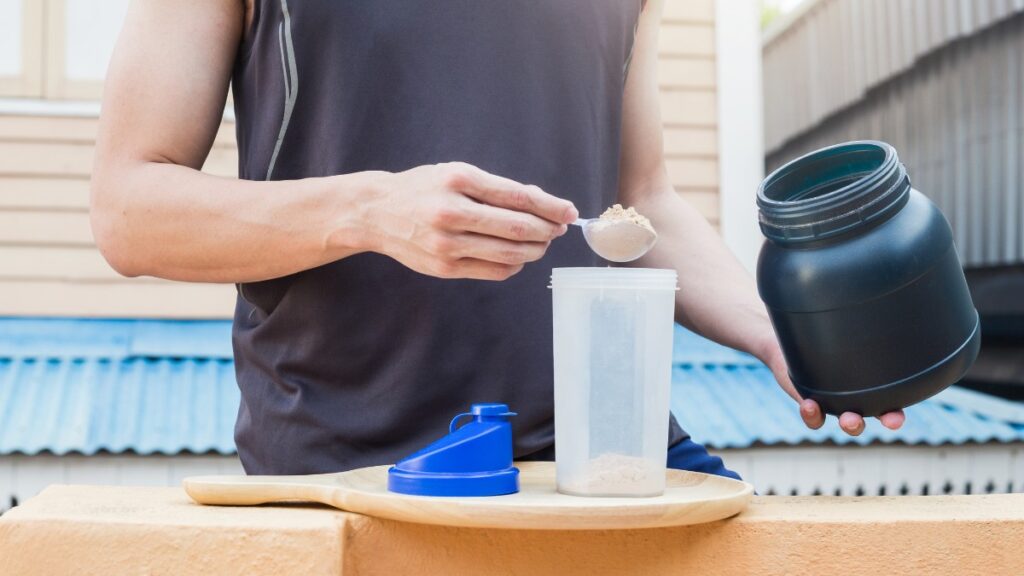 Person mixing creatine in a mixer